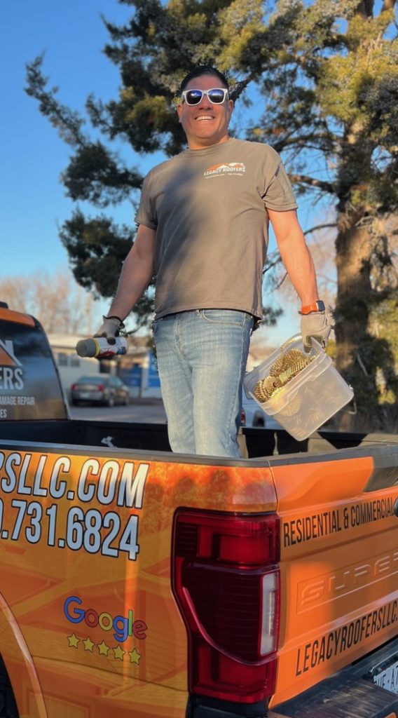 Julian owner of Legacy Roofer on company truck providing residential roof inspection
