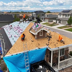 Legacy Roofers Crew working on replacing a damaged roof by hail