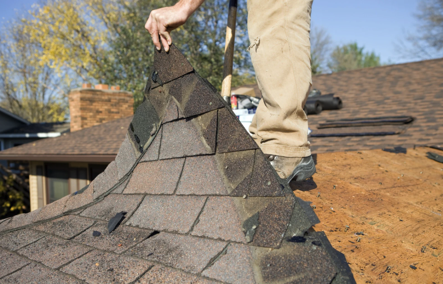 Roof replacement removing damaged shingles by Legacy Roofers
